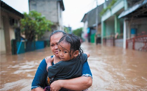 From floodwaters to fires and drought, a changing climate means disaster for many people. PHOTO: KOMPAS / HENDRA A SETYAWAN
