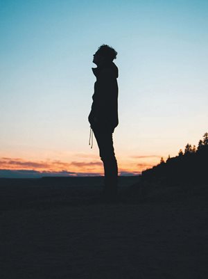 man standing alone in sunset
